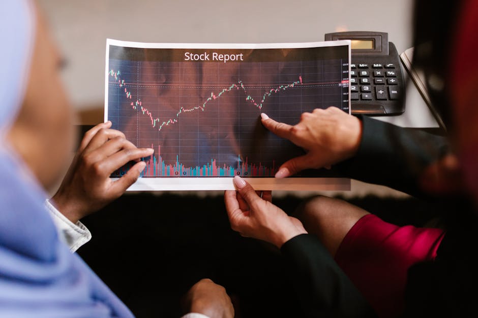 Two professionals discuss a stock report chart in a business meeting, analyzing data trends.